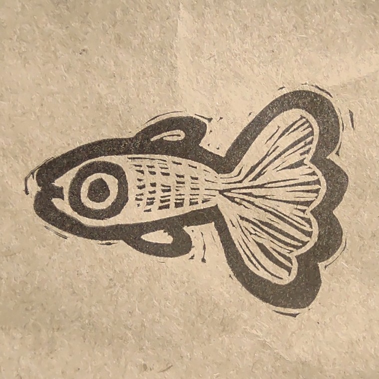 black stamp print on brown paper of a slider turtle and the words viva tortuguita